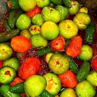 a bowl of tomatoes and peppers in a pan